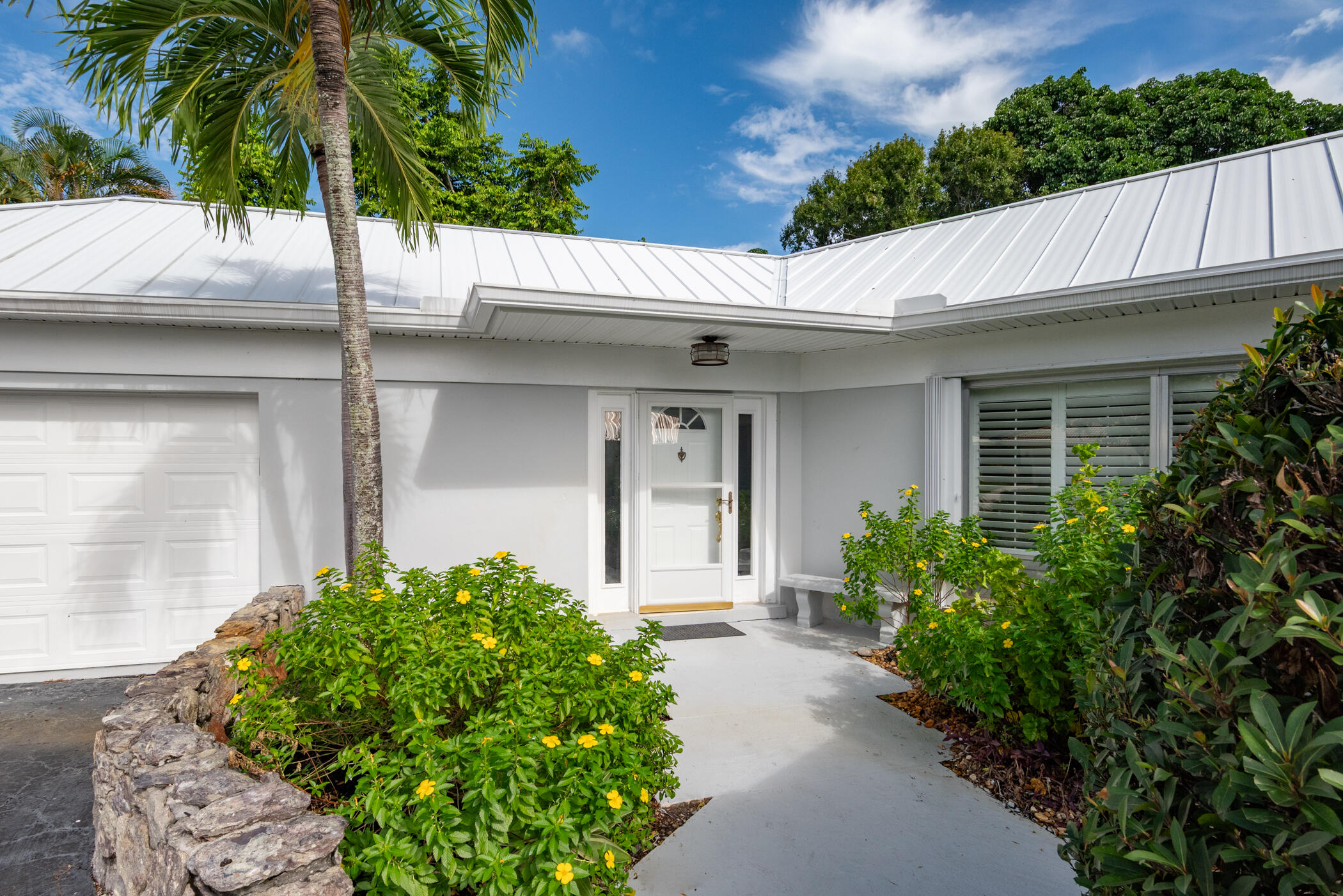 3441 Southeast Court Drive Stuart, FL 34997 - Photo 4 of 46 a view of a house with a small yard and floor to ceiling window
