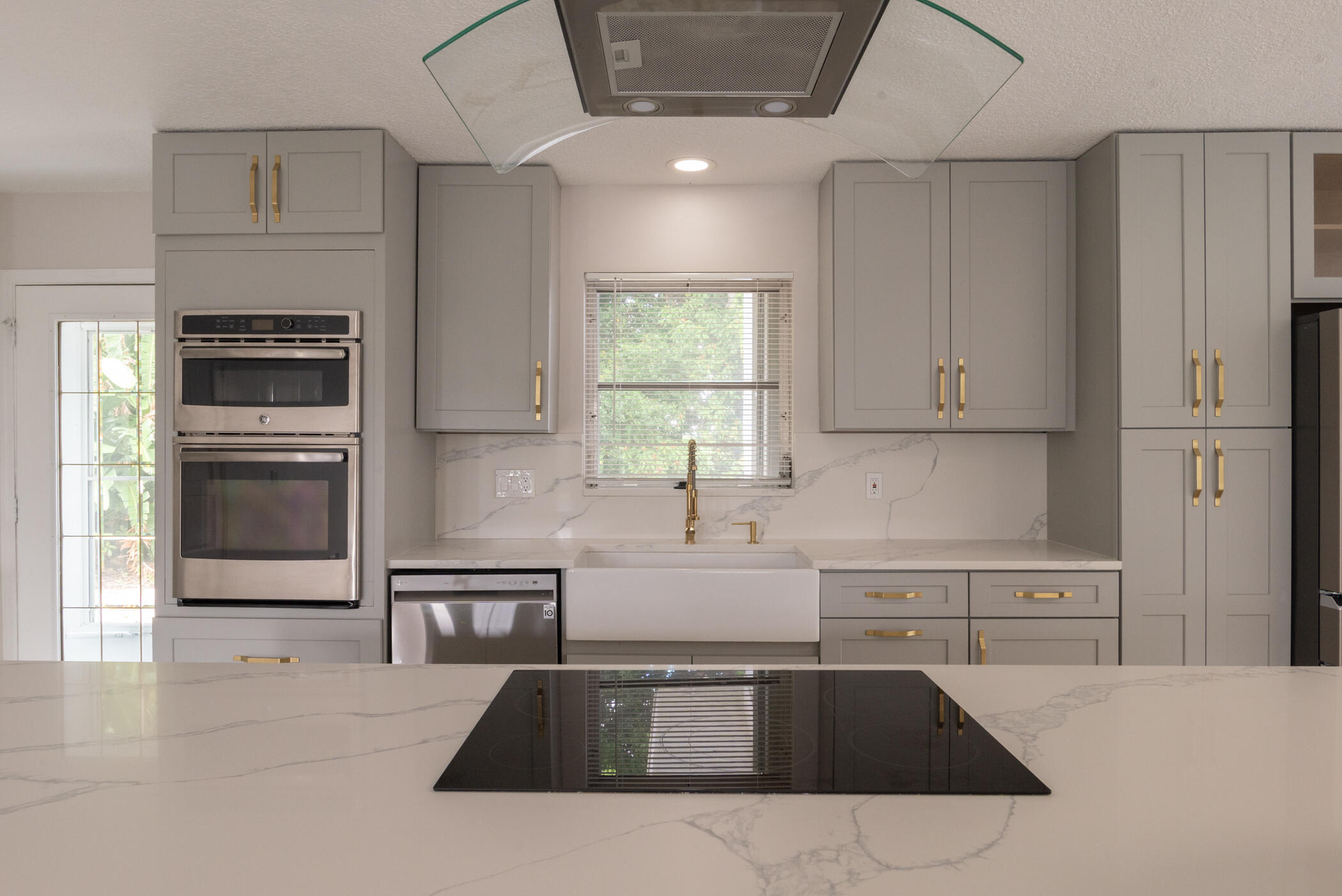 3441 Southeast Court Drive Stuart, FL 34997 - Photo 42 of 46 a kitchen with granite countertop a sink stainless steel appliances and cabinets