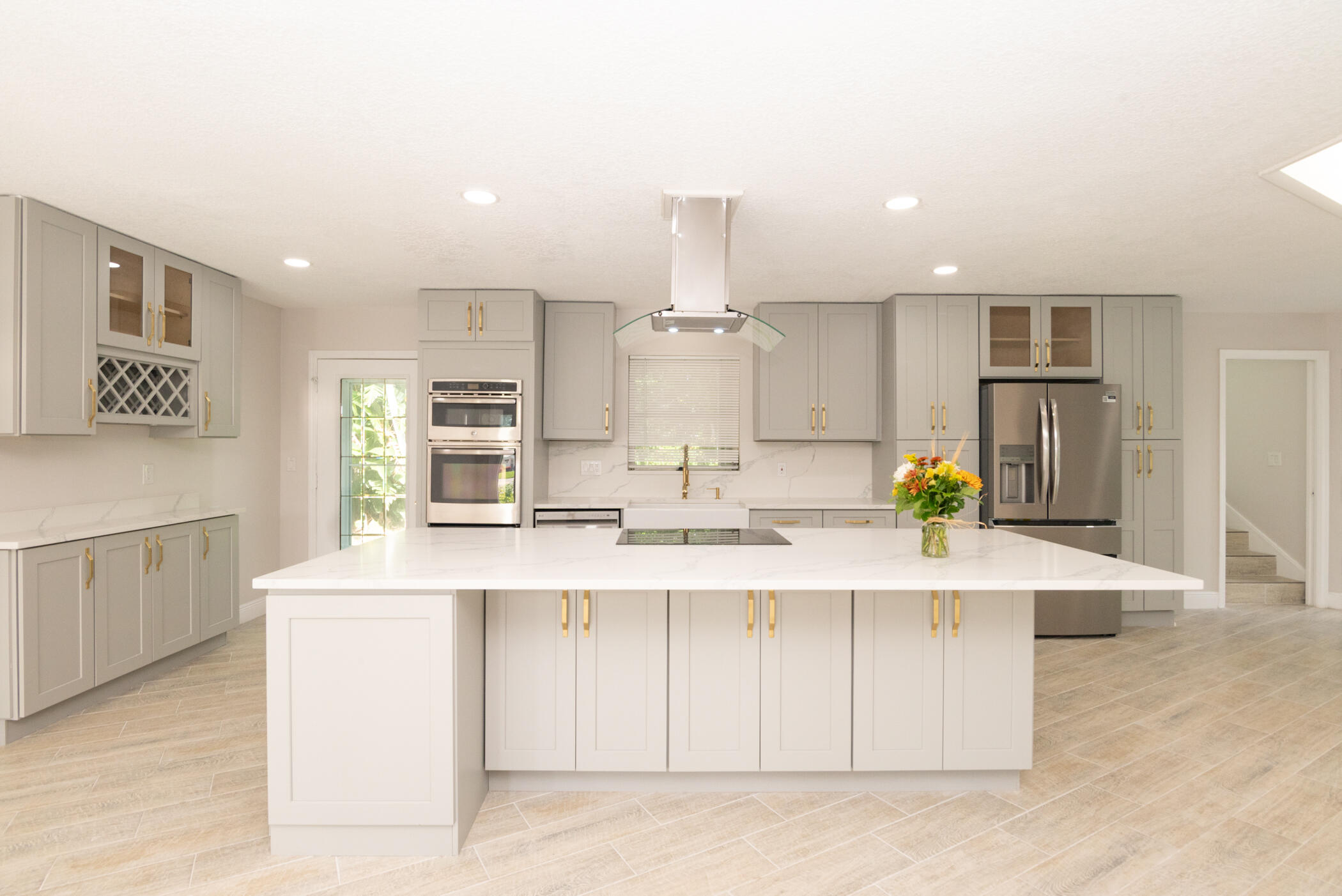 3441 Southeast Court Drive Stuart, FL 34997 - Photo 9 of 46 a kitchen with a sink and white cabinets