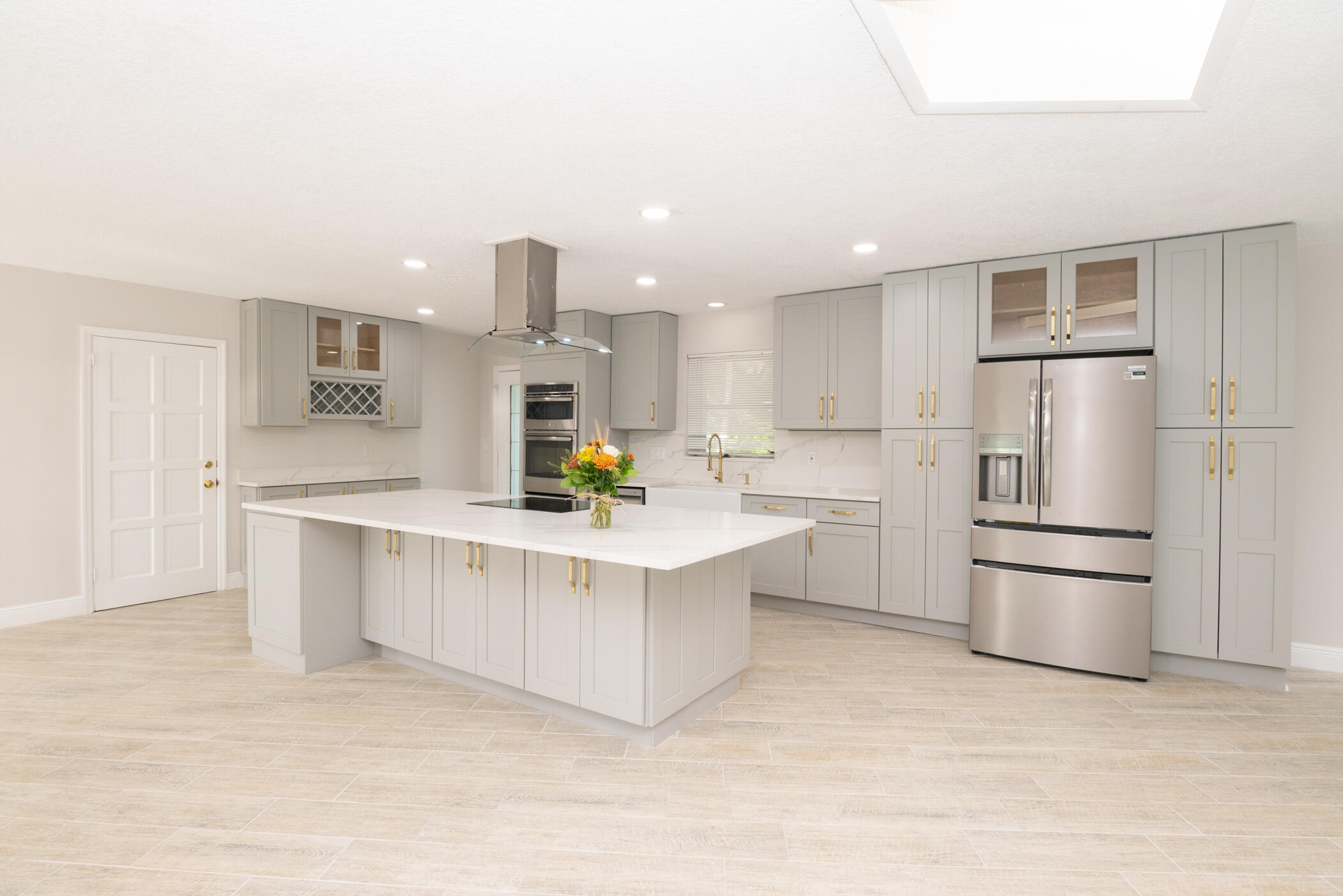 3441 Southeast Court Drive Stuart, FL 34997 - Photo 10 of 46 a kitchen with white cabinets and stainless steel appliances