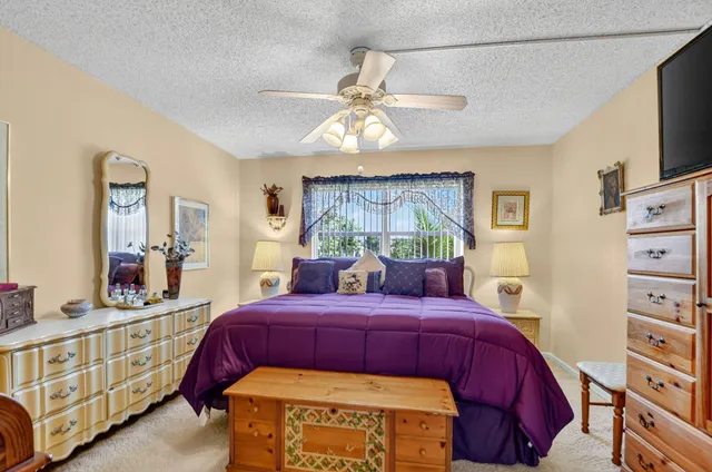 a bedroom with furniture and a flat tv screen