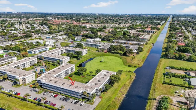 an aerial view of a houses with a swimming pool