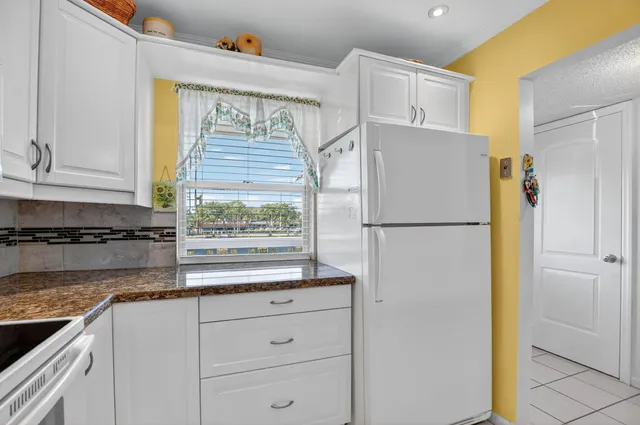 a white refrigerator freezer sitting inside of a kitchen