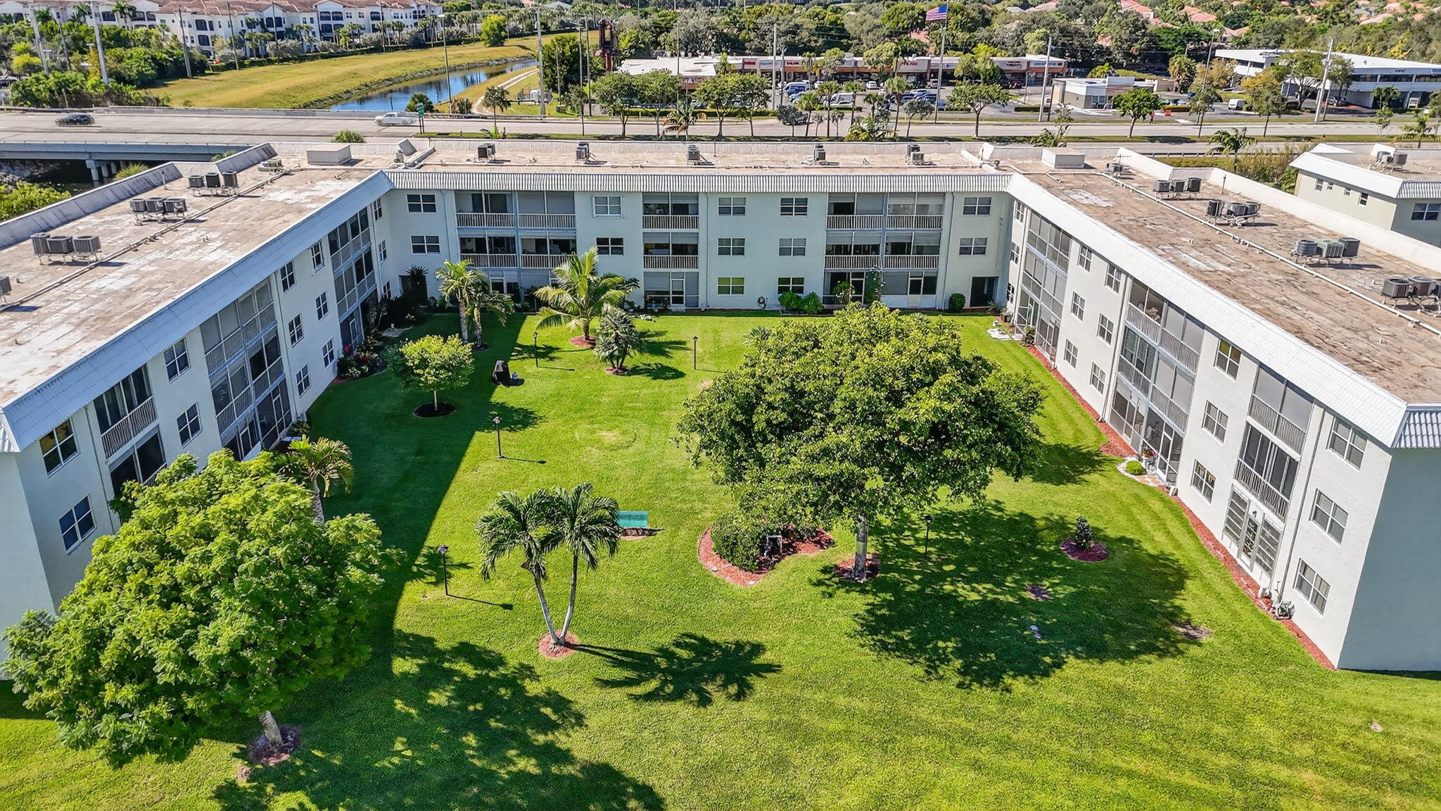 9880 Marina Boulevard, Unit 1522 Boca Raton, FL 33428 - Photo 46 of 52 a view of a swimming pool with a garden