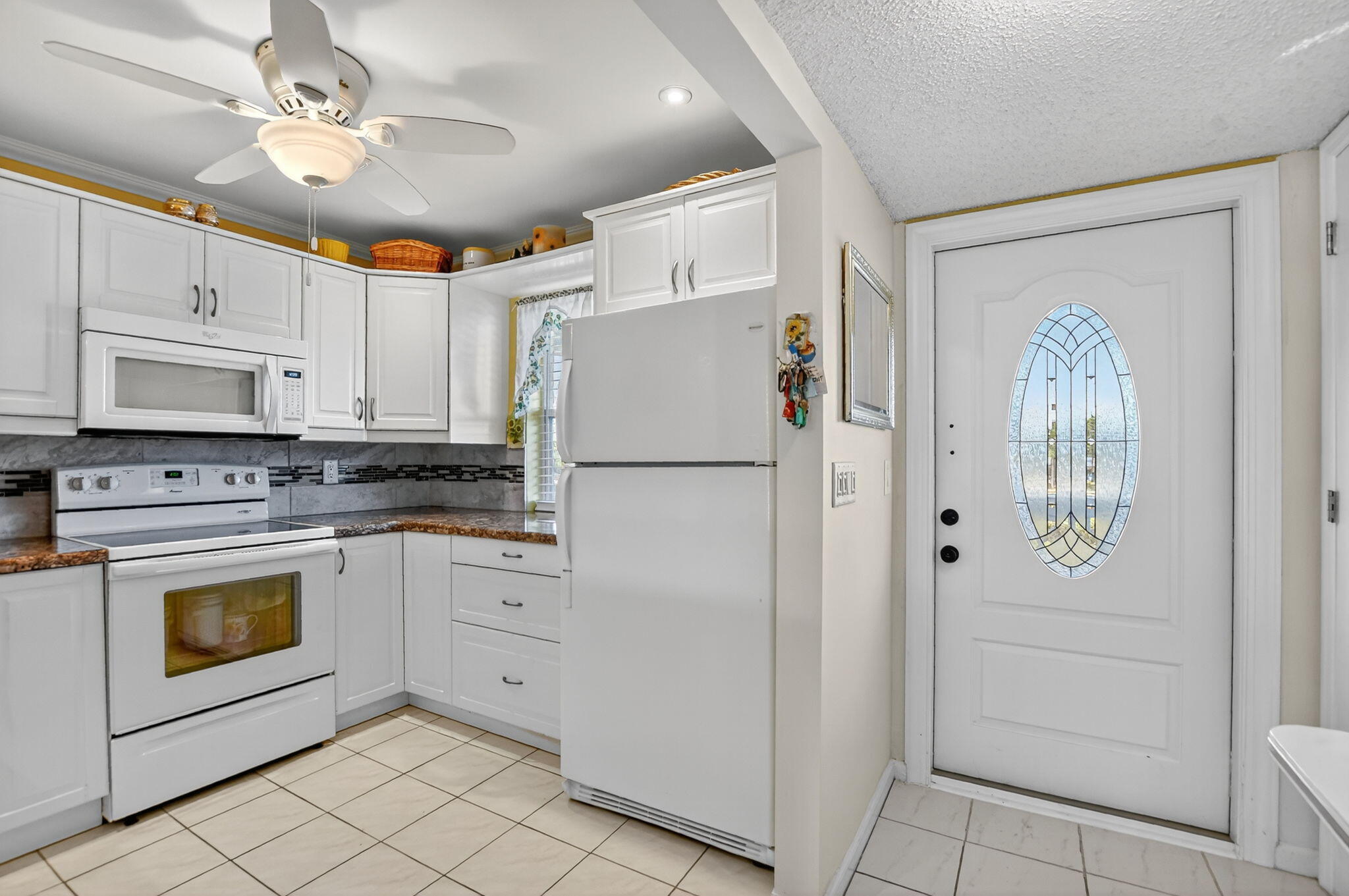 9880 Marina Boulevard, Unit 1522 Boca Raton, FL 33428 - Photo 7 of 52 a white refrigerator freezer and a dishwasher in a kitchen