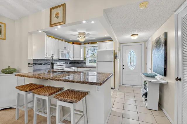 a kitchen with stainless steel appliances granite countertop a stove and a refrigerator