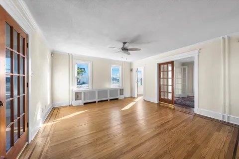 a view of workspace with wooden floor and windows