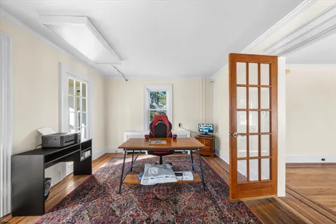 a view of a bedroom with furniture and windows