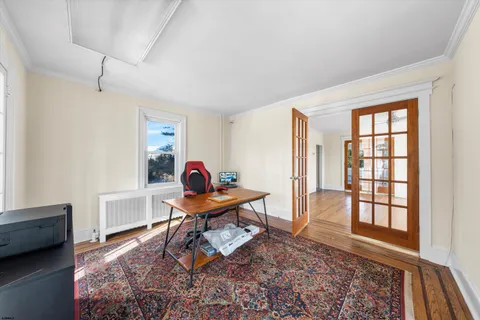 a view of empty room with furniture and window