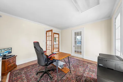 a view of a livingroom with wooden floor and a ceiling fan