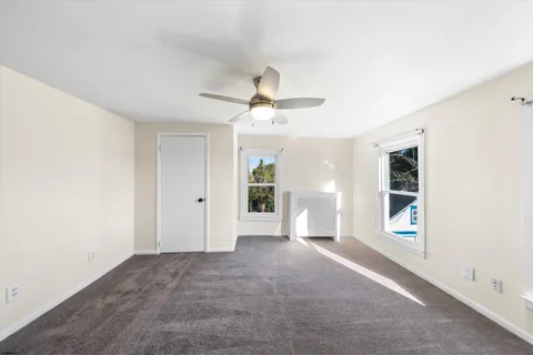 a view of a big room with closet and windows