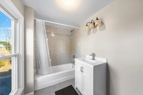 a bathroom with a sink a mirror and a bathtub