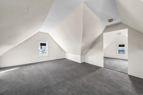 an empty room with a hallway and stairs