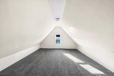 a view of a big room with closet and windows