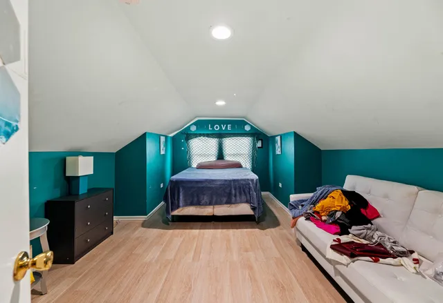 a bedroom with a bed and a dresser