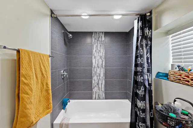 a bathroom with a bathtub and shower