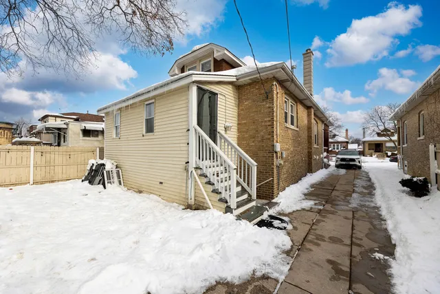 a view of a house with a snow in the background
