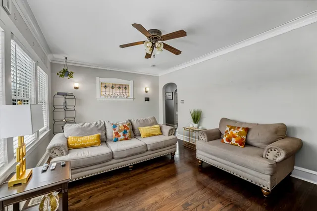 a living room with furniture and a ceiling fan