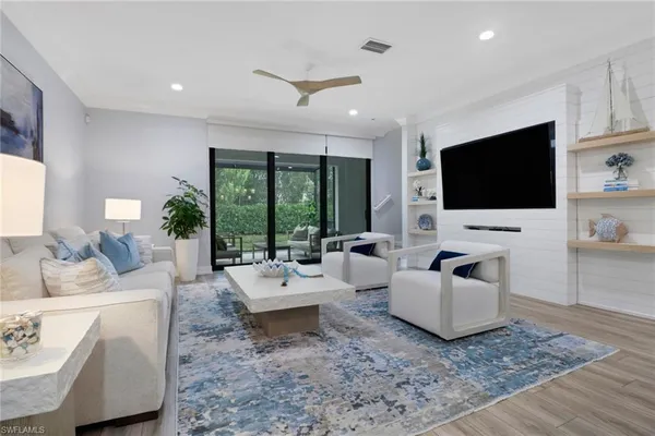a living room with furniture and a flat screen tv
