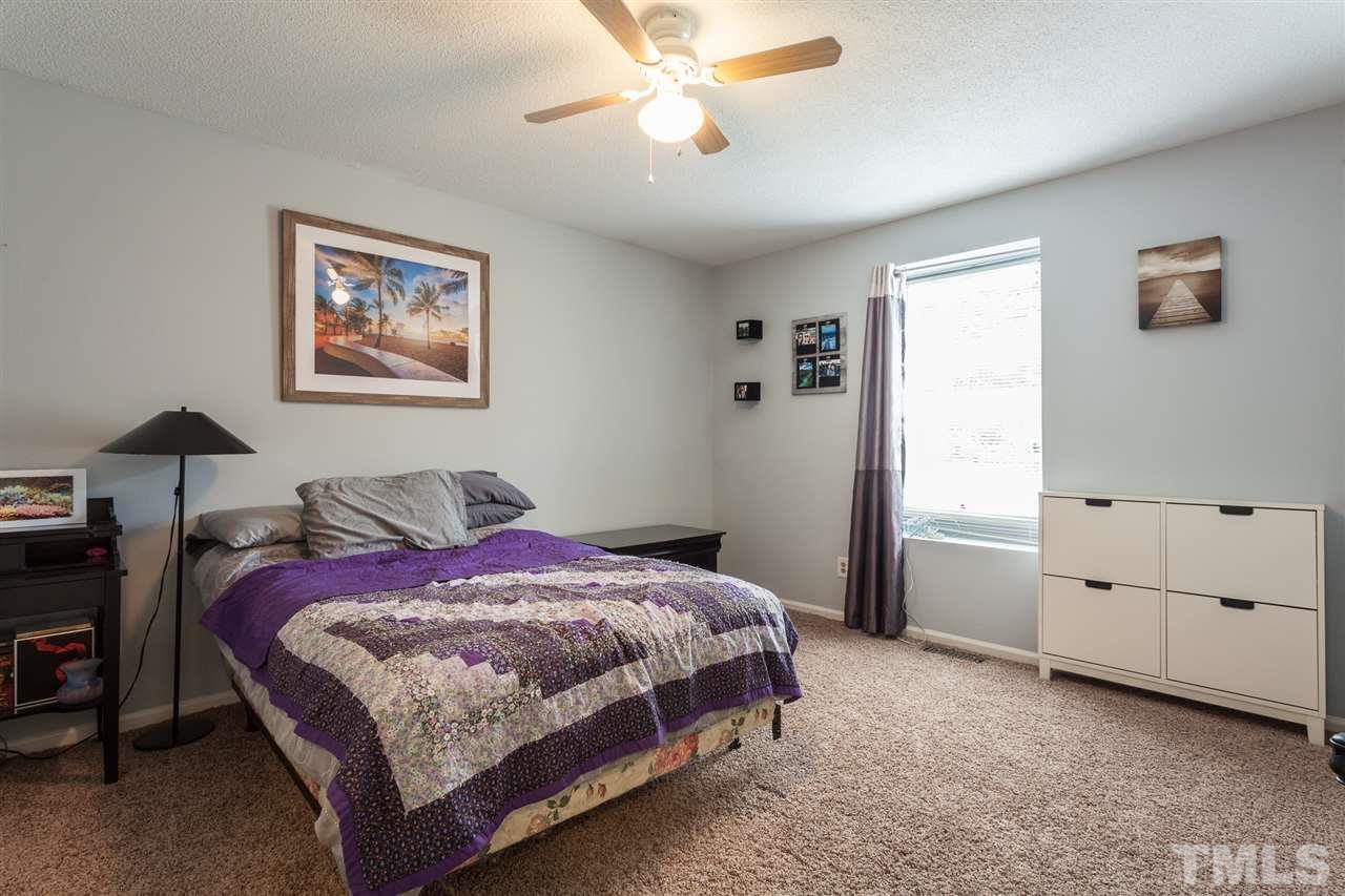 337 East Millbrook Road Raleigh, NC 27609 - Photo 13 of 30 a bedroom with a bed and a chandelier