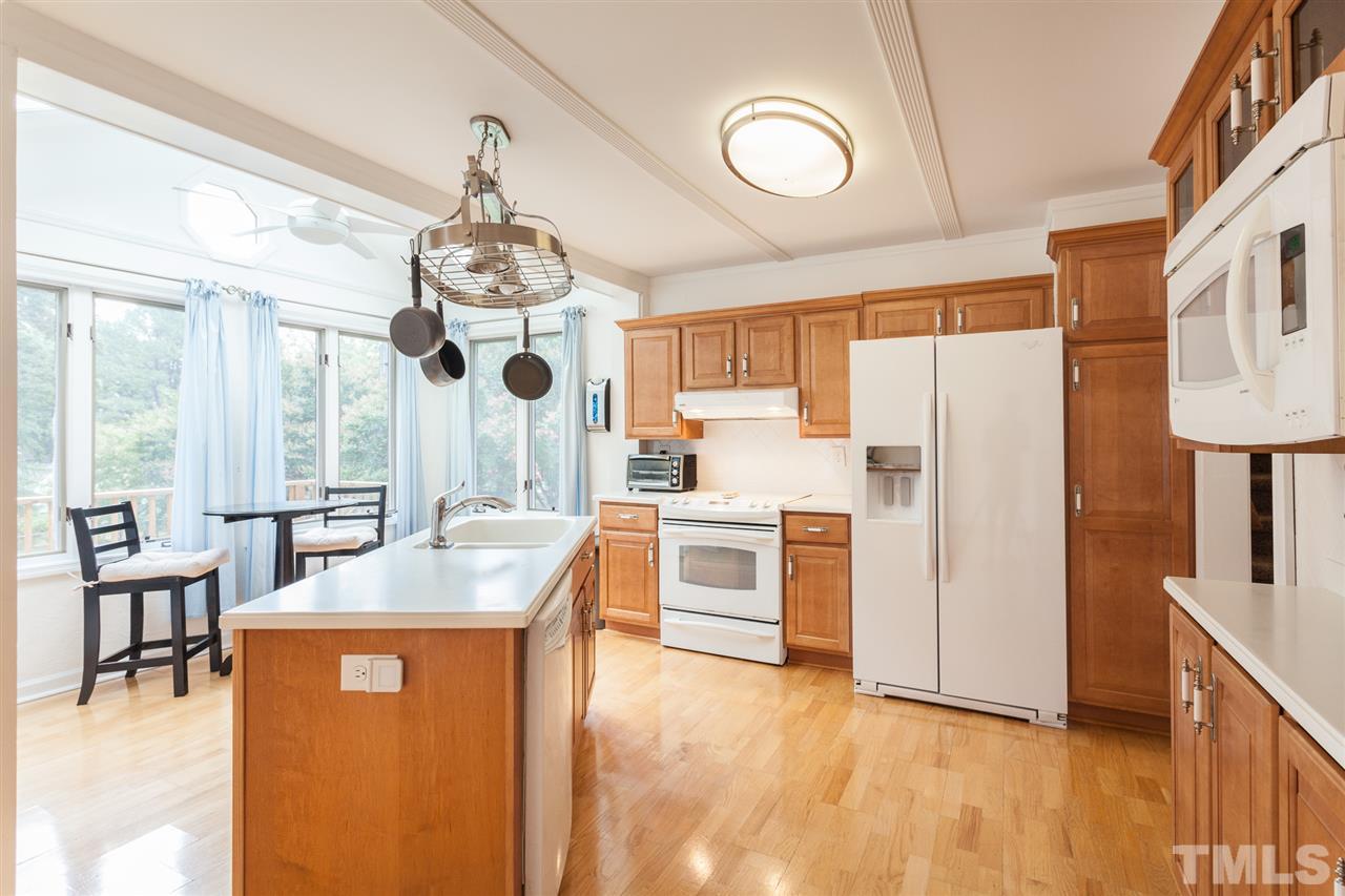 337 East Millbrook Road Raleigh, NC 27609 - Photo 3 of 30 a kitchen with stainless steel appliances granite countertop a refrigerator a oven a sink dishwasher and white cabinets with wooden floor