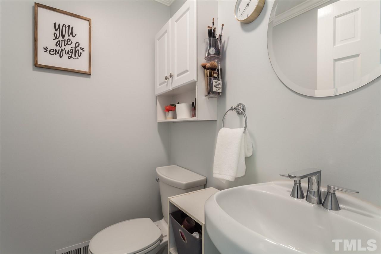 337 East Millbrook Road Raleigh, NC 27609 - Photo 21 of 30 a bathroom with a toilet sink and mirror