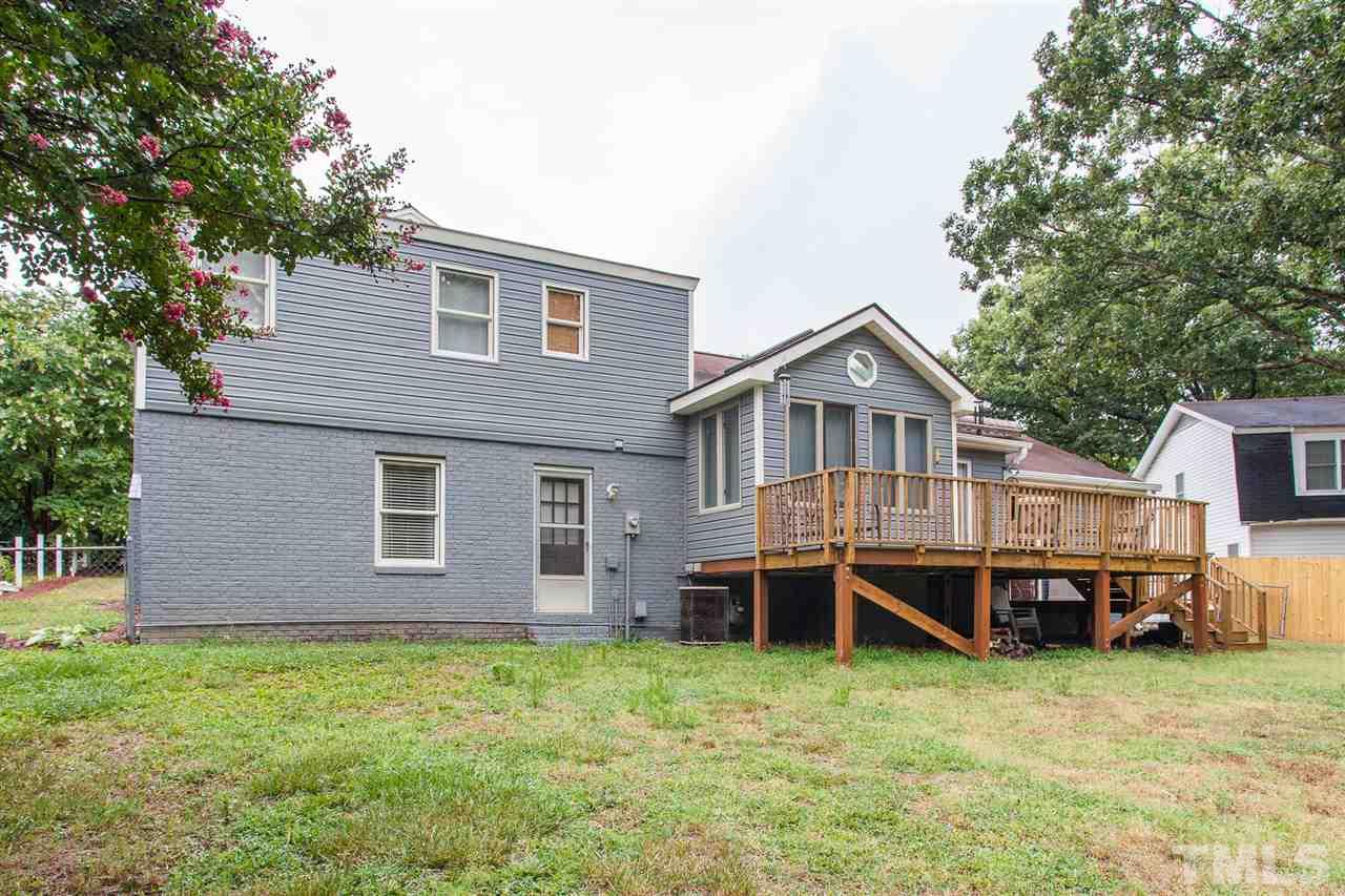 337 East Millbrook Road Raleigh, NC 27609 - Photo 24 of 30 a backyard of a house with wooden deck and barbeque oven