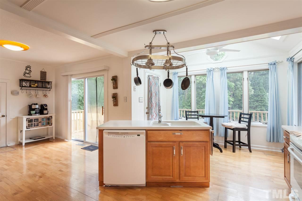337 East Millbrook Road Raleigh, NC 27609 - Photo 4 of 30 a view of a dining room with furniture large windows and wooden floor