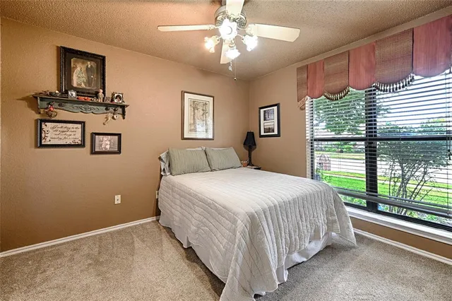 a bedroom with a large bed and a chandelier