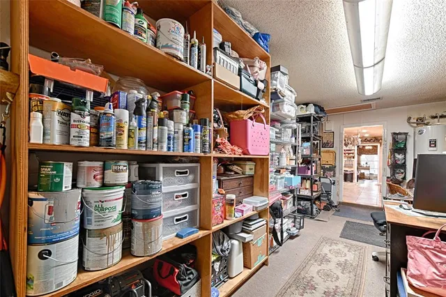 a room with stainless steel appliances kitchen island granite countertop furniture and a sink