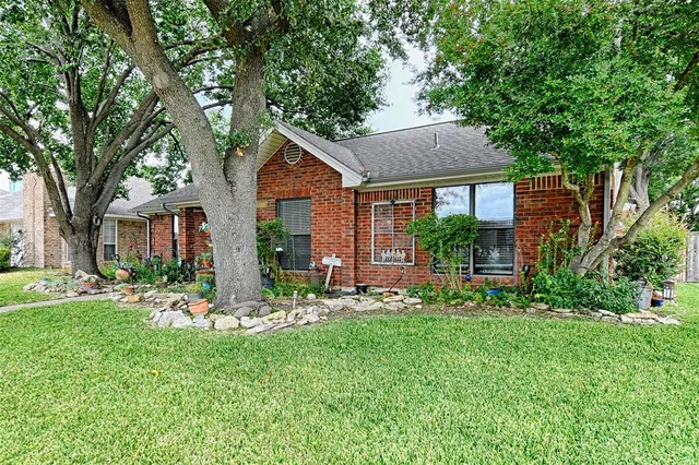 a front view of a house with a yard table and chairs