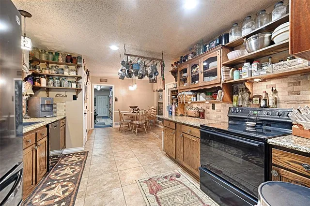 a kitchen with stainless steel appliances granite countertop a stove and a sink