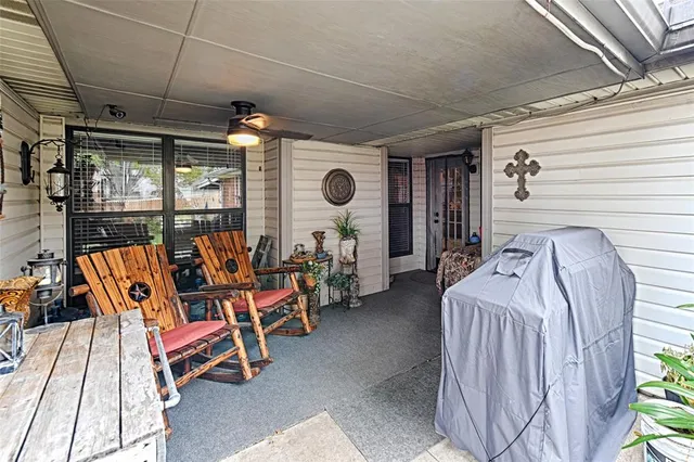 a bedroom with furniture and a large window