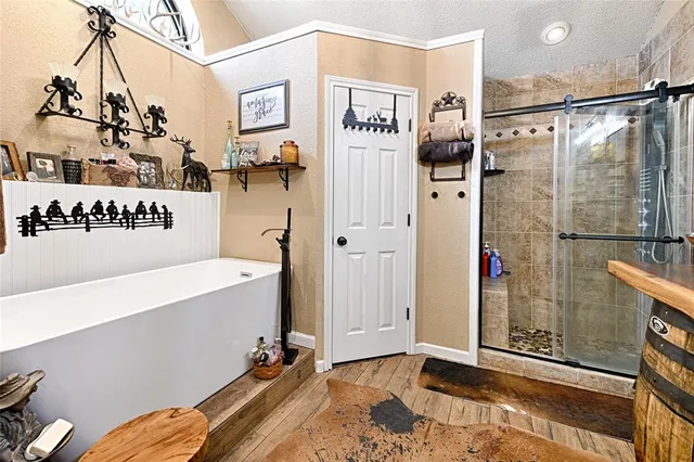 a spacious bedroom with a bed and a chandelier