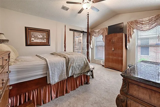 a bedroom with a bed and a dresser in it