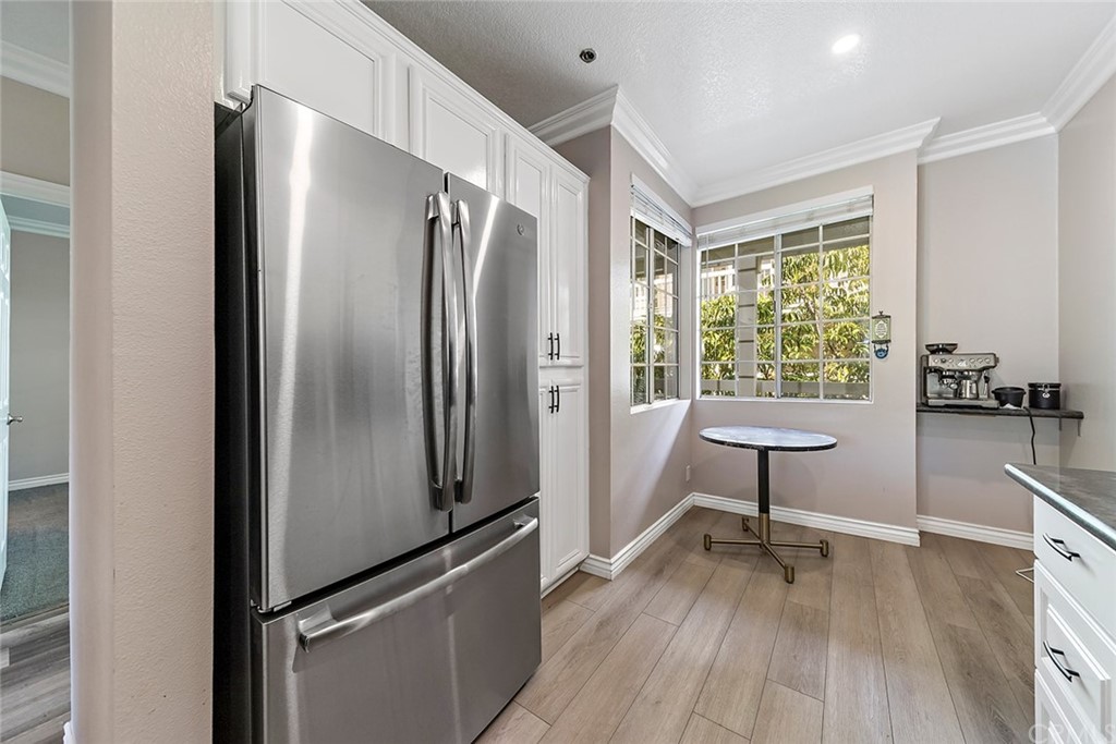 20301 Bluffside Circle, Unit 304 Huntington Beach, CA 92646 - Photo 12 of 40 a kitchen with stainless steel appliances a refrigerator stove and sink