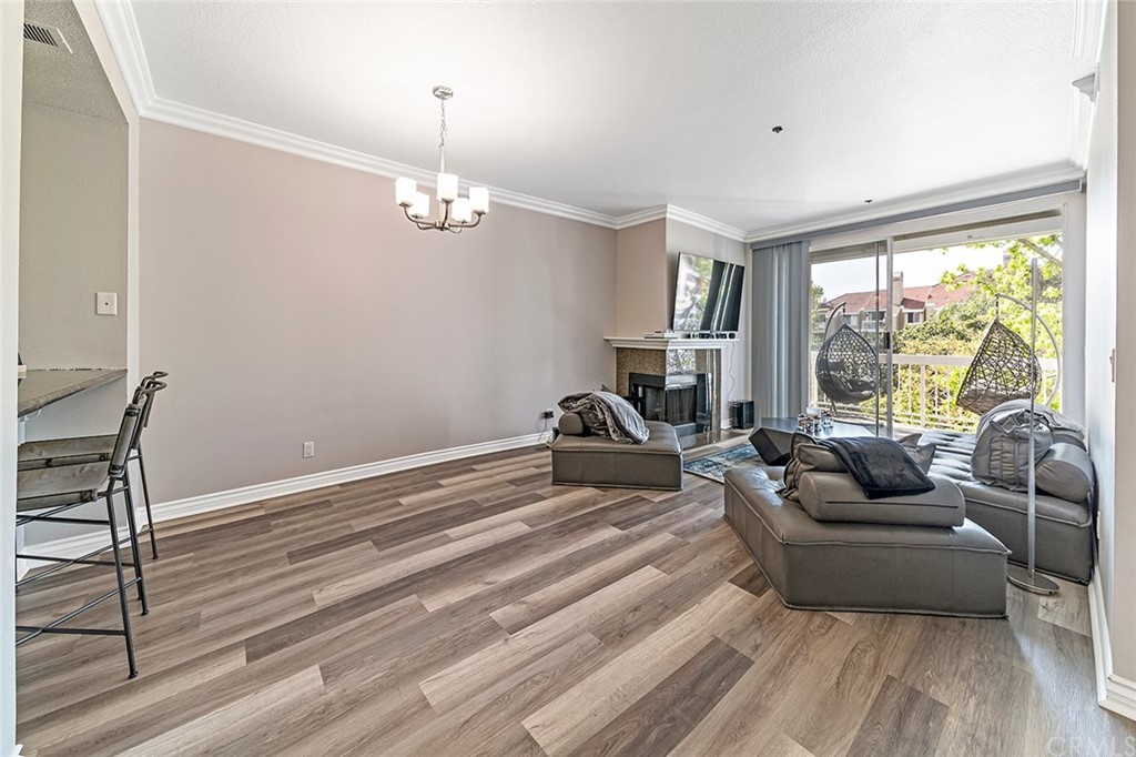 20301 Bluffside Circle, Unit 304 Huntington Beach, CA 92646 - Photo 13 of 40 a living room with furniture and a floor to ceiling window