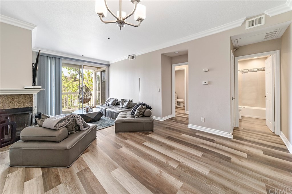 20301 Bluffside Circle, Unit 304 Huntington Beach, CA 92646 - Photo 14 of 40 a living room with furniture and a large window