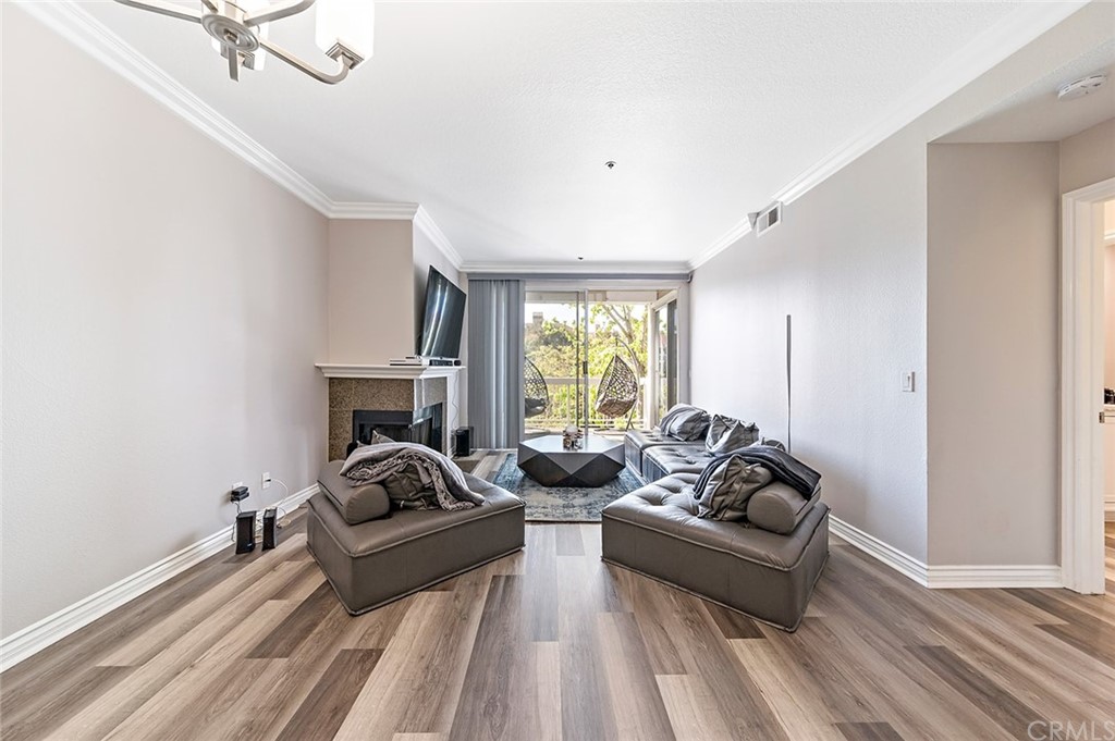 20301 Bluffside Circle, Unit 304 Huntington Beach, CA 92646 - Photo 15 of 40 a living room with furniture and a large window