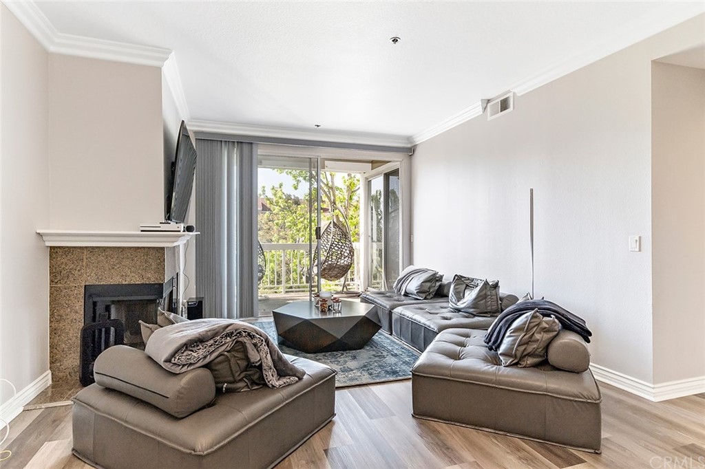 20301 Bluffside Circle, Unit 304 Huntington Beach, CA 92646 - Photo 16 of 40 a living room with furniture window and a fireplace