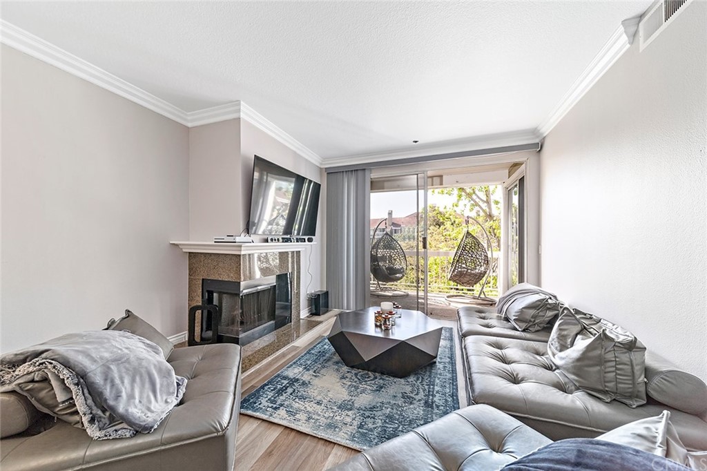 20301 Bluffside Circle, Unit 304 Huntington Beach, CA 92646 - Photo 18 of 40 a living room with furniture fireplace and a large window