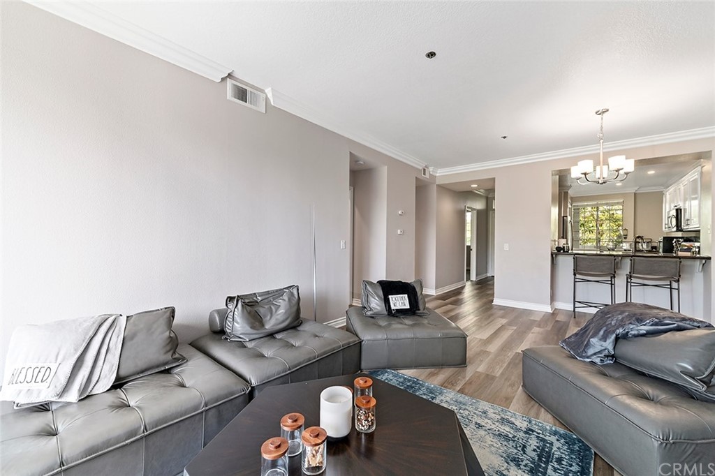 20301 Bluffside Circle, Unit 304 Huntington Beach, CA 92646 - Photo 19 of 40 a living room with furniture and view of kitchen