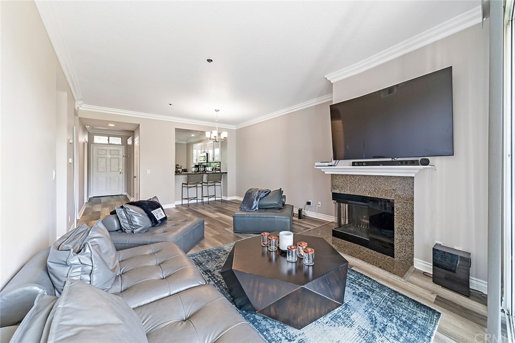 20301 Bluffside Circle, Unit 304 Huntington Beach, CA 92646 - Photo 20 of 40 a living room with furniture a flat screen tv and a fireplace
