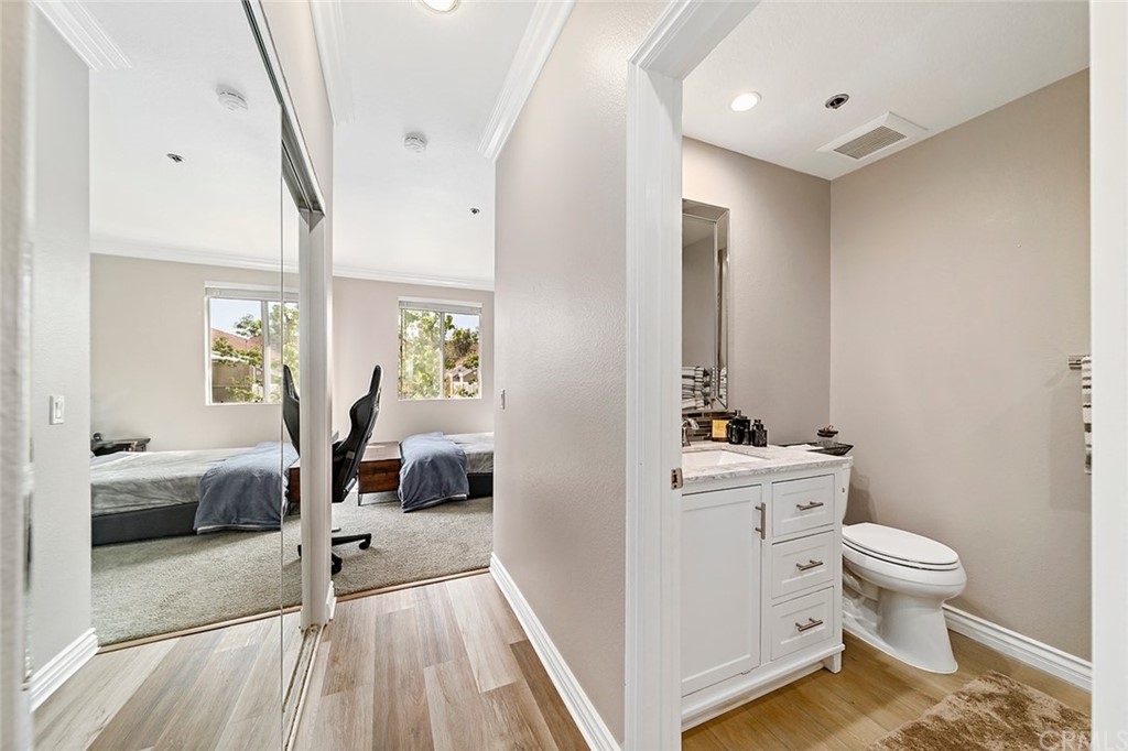 20301 Bluffside Circle, Unit 304 Huntington Beach, CA 92646 - Photo 23 of 40 a bedroom with a bed and a view of bathroom
