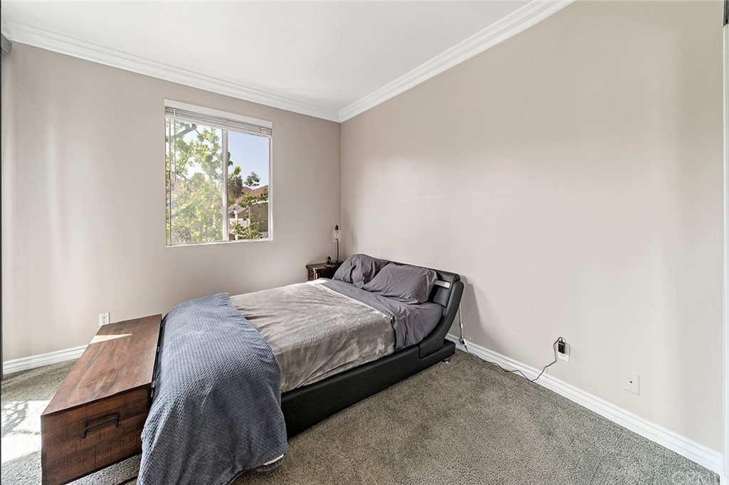 20301 Bluffside Circle, Unit 304 Huntington Beach, CA 92646 - Photo 25 of 40 a bedroom with a bed and a window