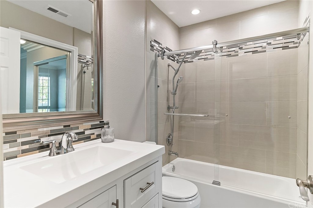 20301 Bluffside Circle, Unit 304 Huntington Beach, CA 92646 - Photo 28 of 40 a bathroom with a sink a toilet and a mirror