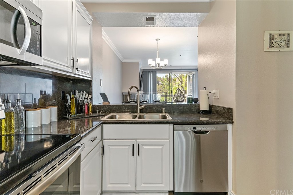 20301 Bluffside Circle, Unit 304 Huntington Beach, CA 92646 - Photo 7 of 40 a kitchen with a sink and cabinets