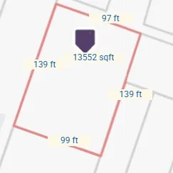 a street sign on a wall next to a road