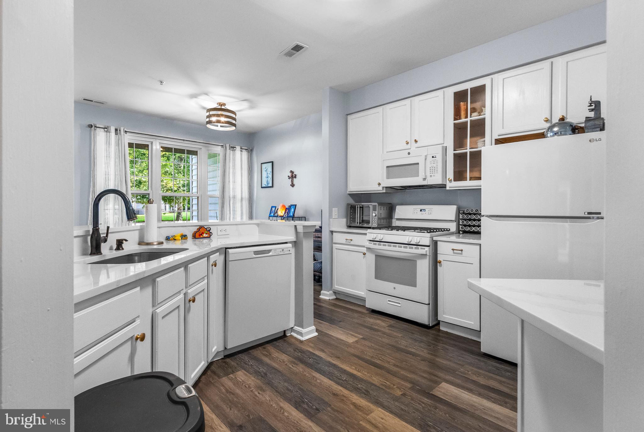 142 Rosebay Court Delran, NJ 08075 - Photo 4 of 13 a kitchen with white cabinets and white appliances