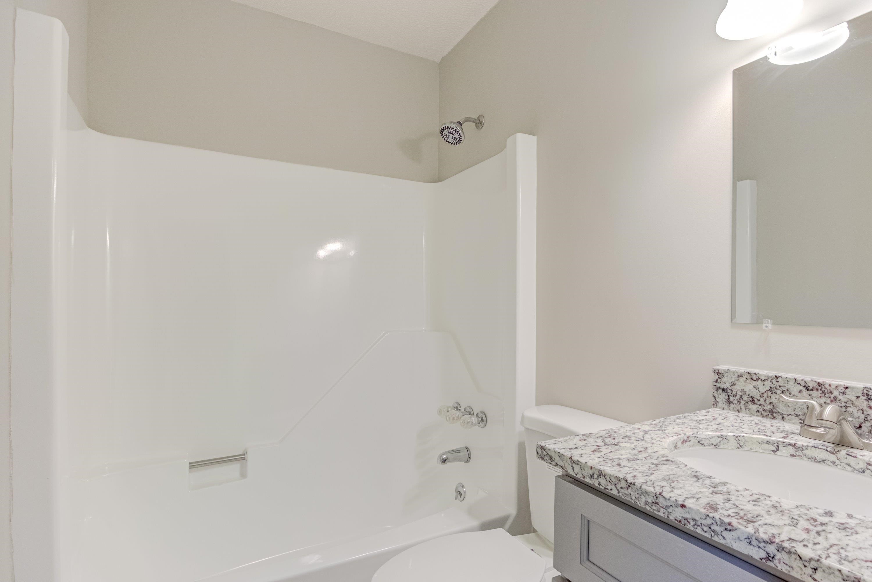 5404 Pear Orchard Lane Raleigh, NC 27616 - Photo 12 of 22 a bathroom with a granite countertop sink a toilet and shower